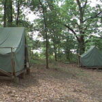 Photo of a standard campsite with tents on platforms